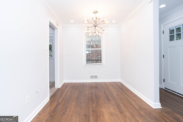 unfurnished dining area with an inviting chandelier, dark hardwood / wood-style floors, and crown molding