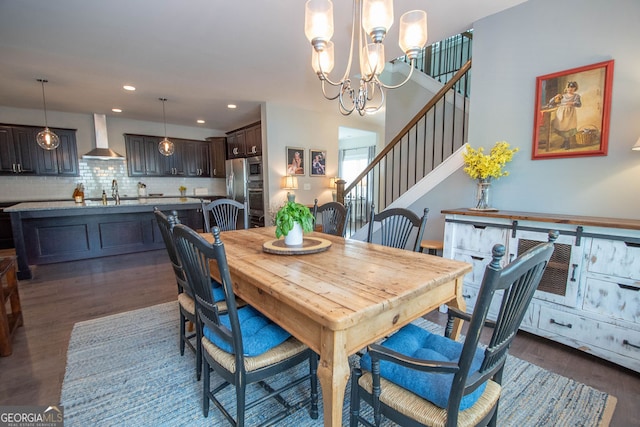 dining space featuring a notable chandelier, dark hardwood / wood-style floors, and sink