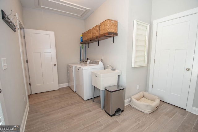 laundry area featuring light hardwood / wood-style floors and separate washer and dryer