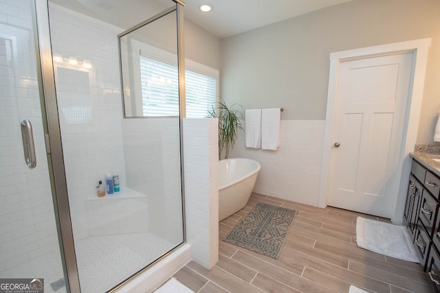 bathroom featuring vanity and separate shower and tub