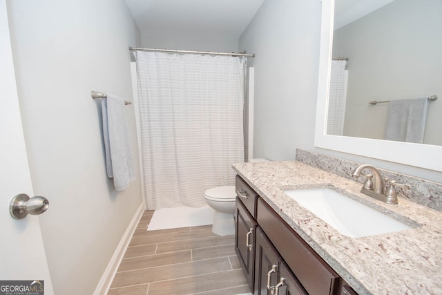 bathroom with vanity, toilet, hardwood / wood-style floors, and curtained shower