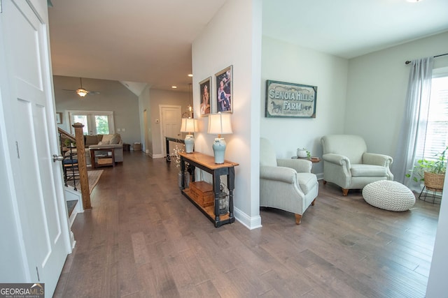 interior space with dark wood-type flooring and ceiling fan