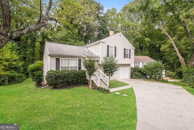 split level home featuring a garage and a front yard