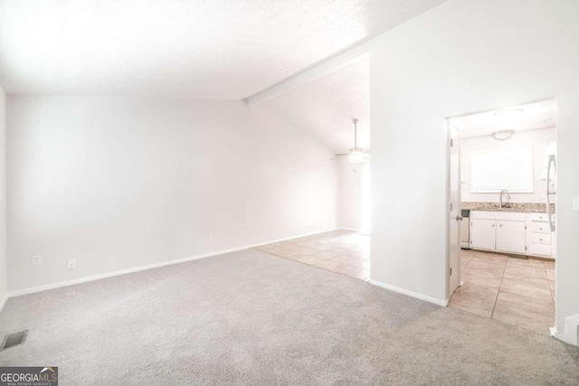 additional living space with visible vents, baseboards, lofted ceiling with beams, light carpet, and a ceiling fan