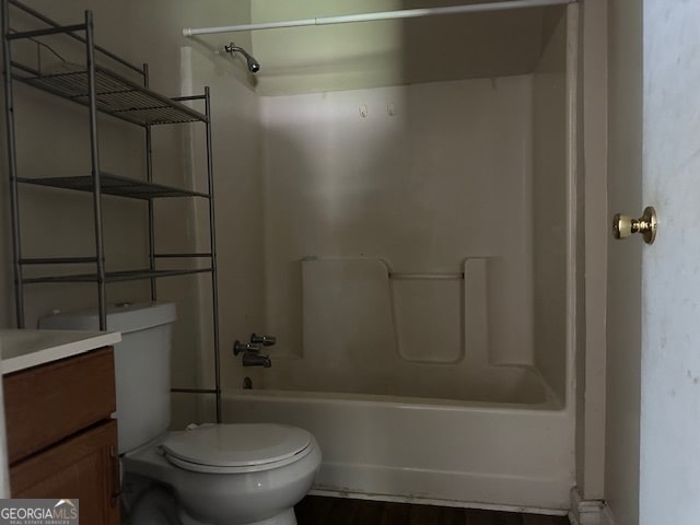 full bathroom featuring wood-type flooring, vanity, toilet, and washtub / shower combination