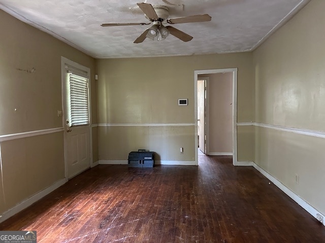 spare room with a textured ceiling, dark hardwood / wood-style flooring, and ceiling fan