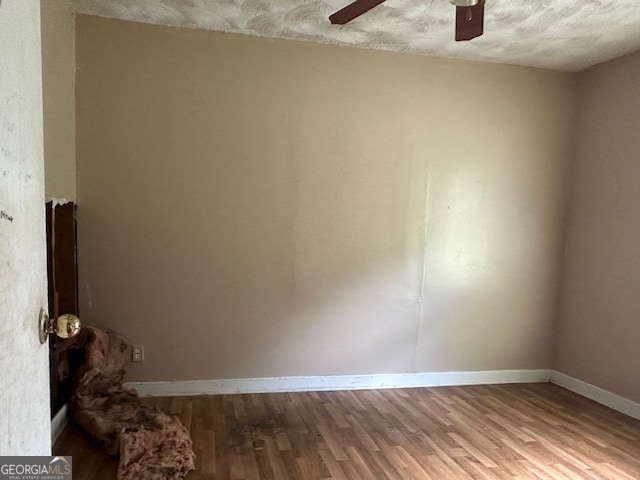 unfurnished room featuring ceiling fan, a textured ceiling, and hardwood / wood-style floors