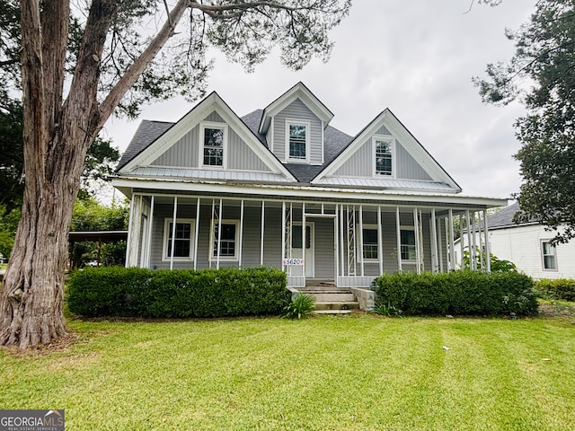 view of front of home with a porch and a front lawn