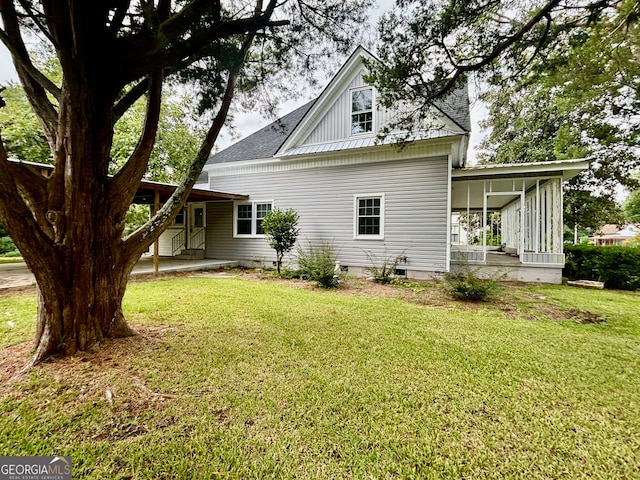 view of property exterior with a lawn and a sunroom