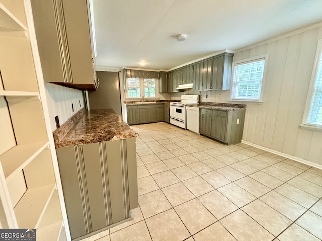 kitchen featuring sink, light tile patterned floors, and white appliances