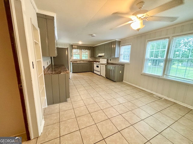 kitchen featuring light tile patterned floors, crown molding, white stove, gray cabinets, and ceiling fan