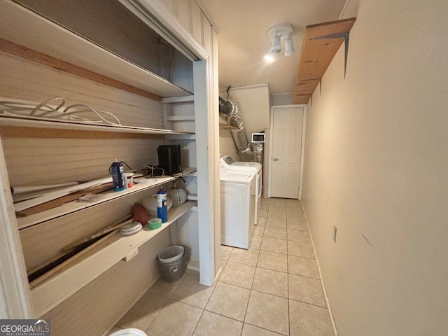 clothes washing area featuring washer and dryer and light tile patterned floors