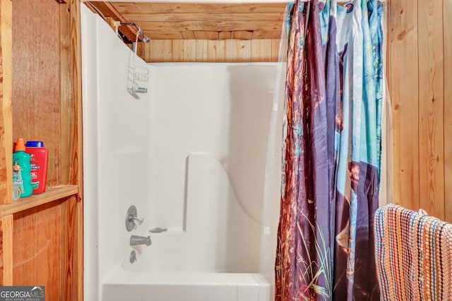 bathroom featuring wood walls, wooden ceiling, and shower / bath combo