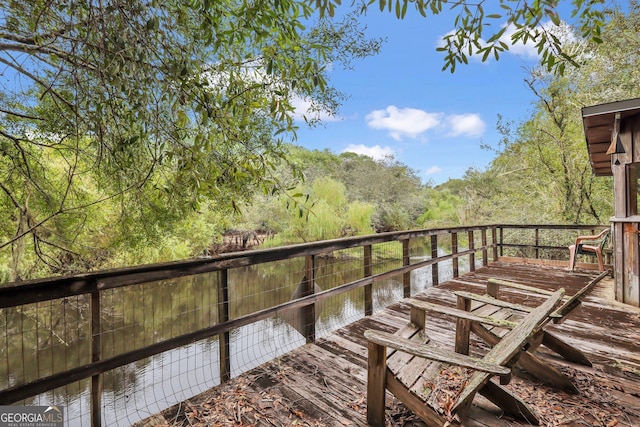 wooden deck featuring a water view