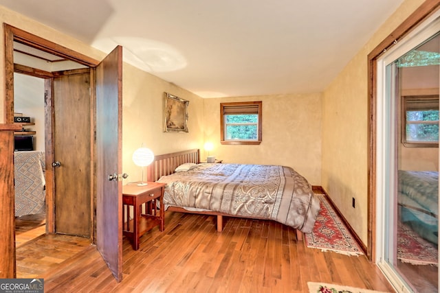 bedroom with hardwood / wood-style floors