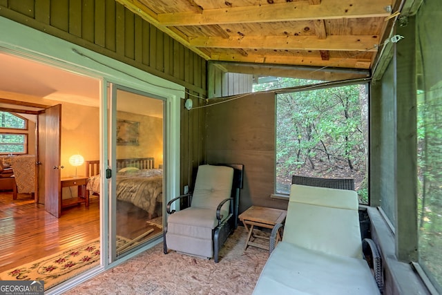 sunroom / solarium featuring wood ceiling and vaulted ceiling with beams