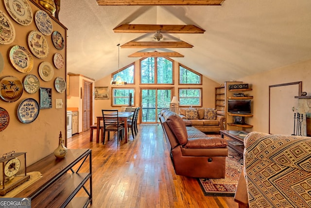 living room with a textured ceiling, high vaulted ceiling, beam ceiling, and hardwood / wood-style flooring