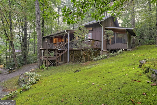 exterior space featuring a lawn and a sunroom