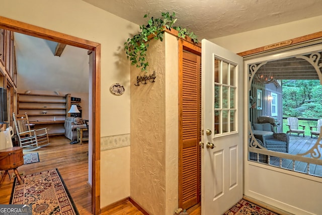 entryway featuring a textured ceiling and hardwood / wood-style flooring