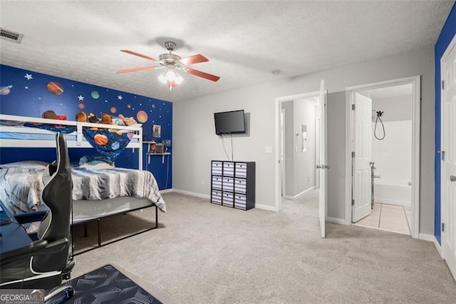 carpeted bedroom featuring connected bathroom, ceiling fan, and a textured ceiling