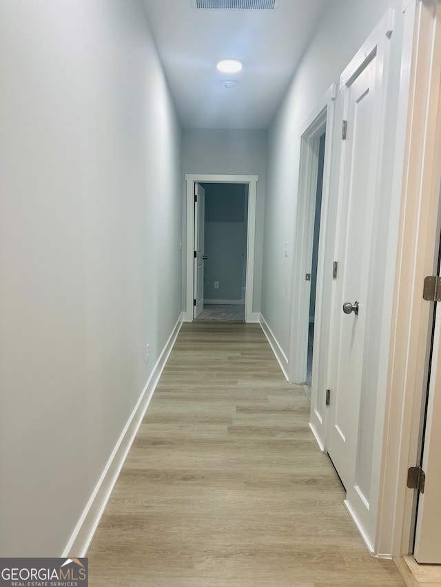 hallway with light wood-type flooring