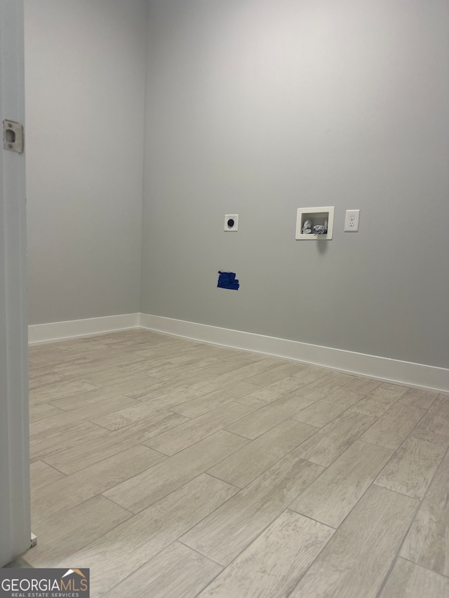 laundry area featuring washer hookup, light hardwood / wood-style floors, and hookup for an electric dryer