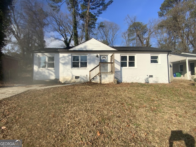 view of front of property with a front yard and a carport