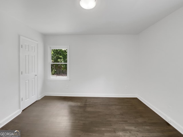 spare room with dark wood-type flooring