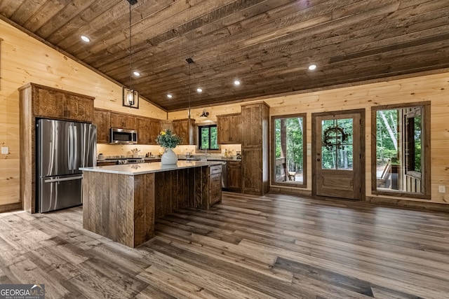 kitchen with pendant lighting, dark hardwood / wood-style flooring, stainless steel appliances, and wooden ceiling