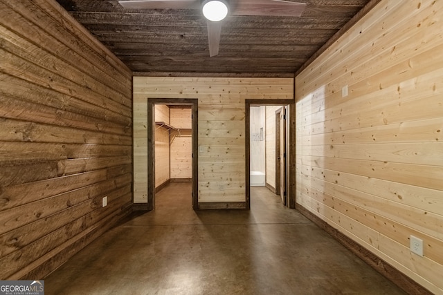 hallway with wooden ceiling and wooden walls