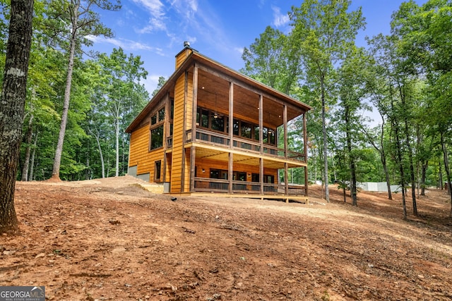 back of property featuring a balcony