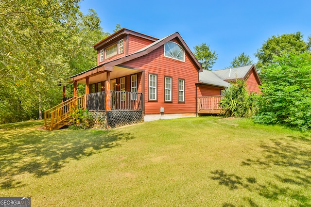 rear view of property featuring a lawn