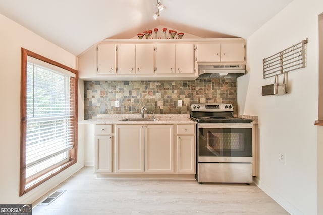 kitchen featuring stainless steel electric range oven, lofted ceiling, tasteful backsplash, and light hardwood / wood-style flooring