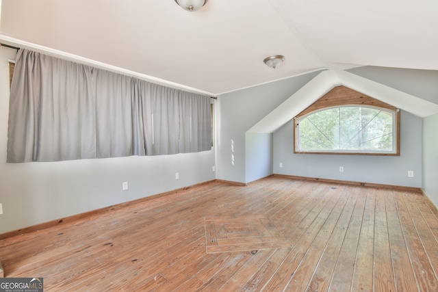 bonus room featuring vaulted ceiling and light hardwood / wood-style floors