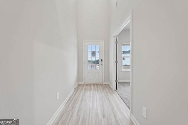 hall with light hardwood / wood-style floors