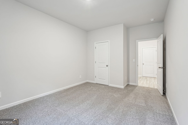 unfurnished bedroom featuring light carpet