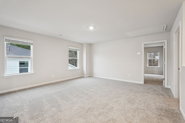 spare room with plenty of natural light and light carpet