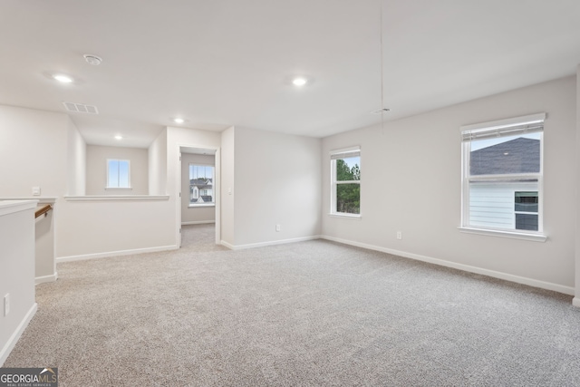 empty room featuring light carpet