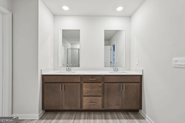 bathroom featuring vanity, hardwood / wood-style flooring, and walk in shower