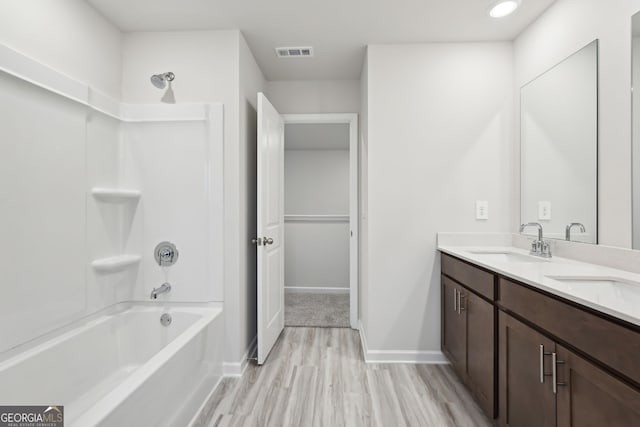 bathroom with vanity, wood-type flooring, and bathing tub / shower combination