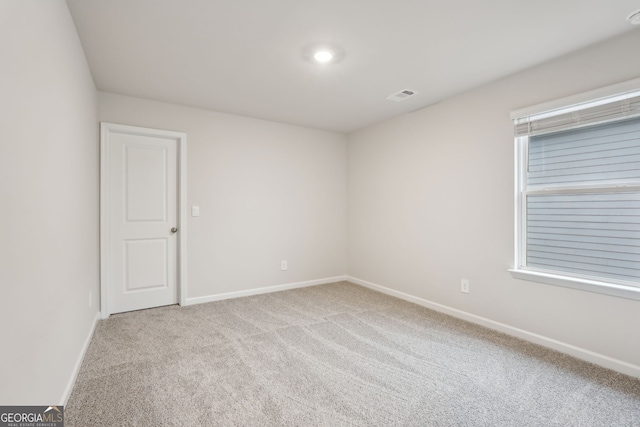 carpeted empty room featuring plenty of natural light