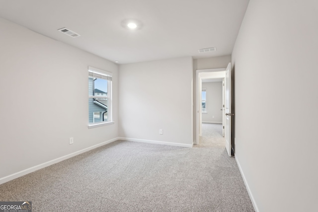 unfurnished room with light carpet