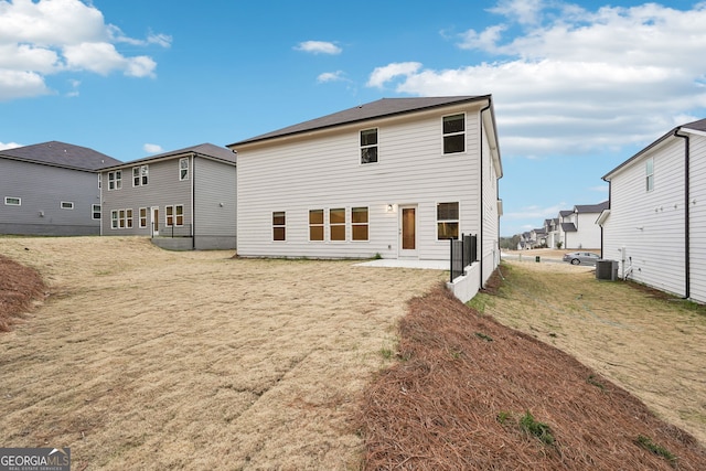 back of house with a yard, central AC unit, and a patio area