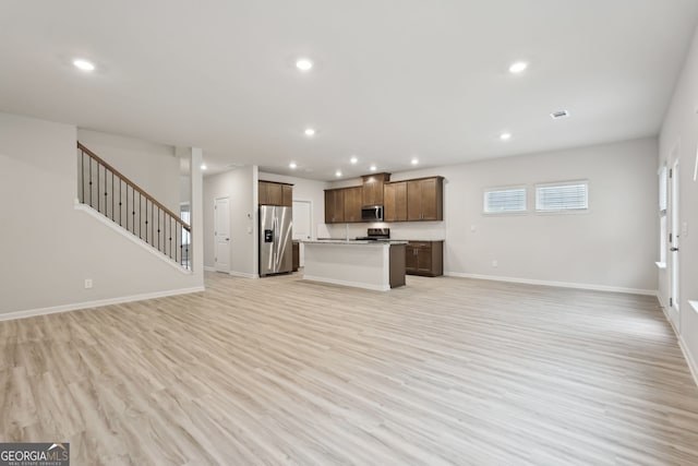 unfurnished living room with light hardwood / wood-style flooring