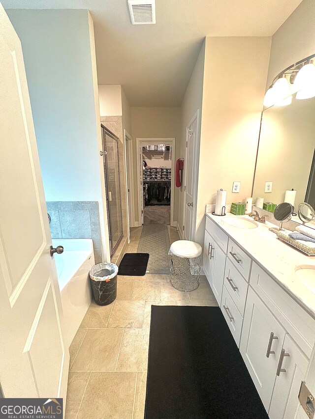 bathroom with shower with separate bathtub and vanity