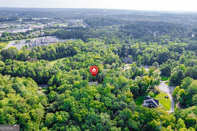 birds eye view of property with a view of trees