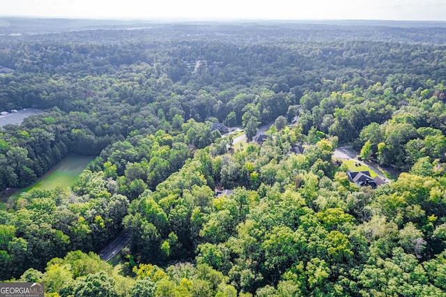 birds eye view of property featuring a forest view