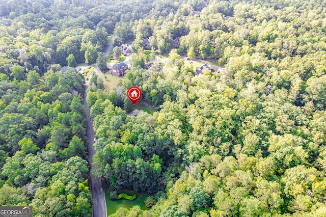 birds eye view of property featuring a view of trees