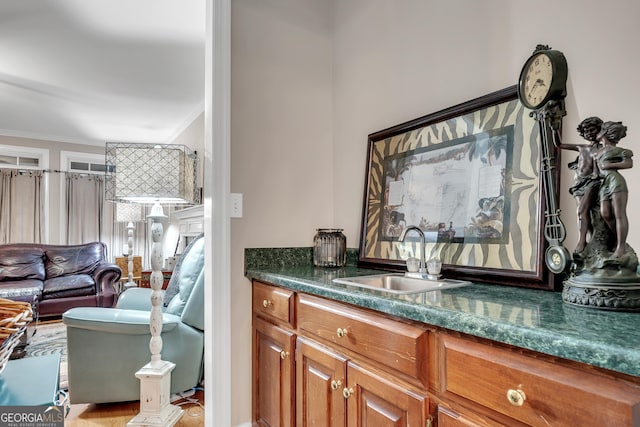 bar with a sink and ornamental molding