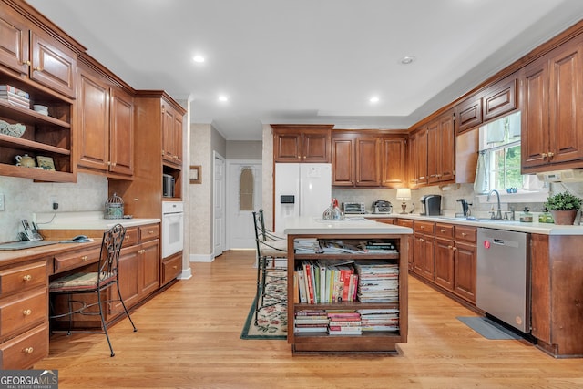 kitchen featuring open shelves, light countertops, white appliances, and light wood-type flooring